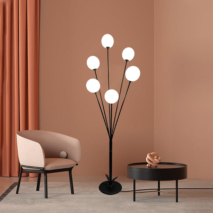 A modern floor lamp with a black iron stand and white  shades standing inliving room auckland