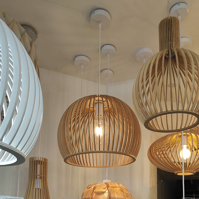 Wooden pendant lights hanging from the ceiling in a showroom setting nz